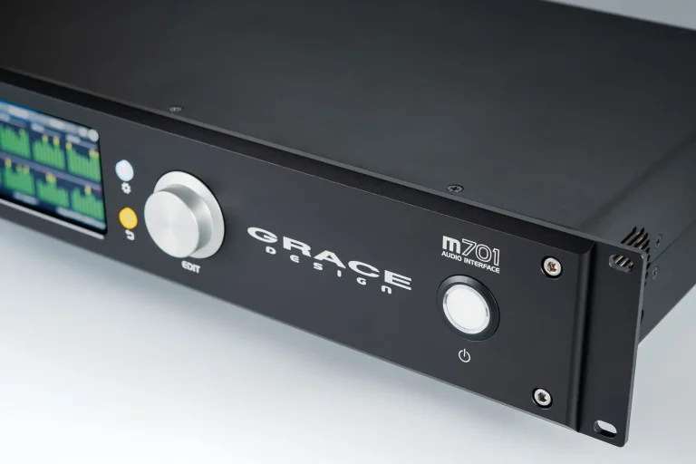 Grace Design m701 Audio Interface front panel featuring a color display, rotary dial, and power button.