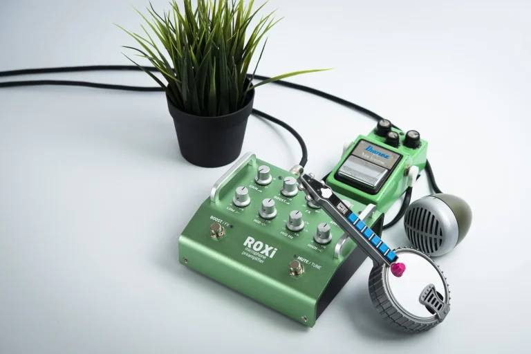 Grace Design ROXi microphone preamplifier pedal shown with a microphone, demonstrating professional studio hardware for