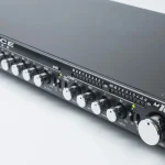 Grace Design m1033 channel strip unit featuring precision control knobs, LED meters, and a black faceplate.