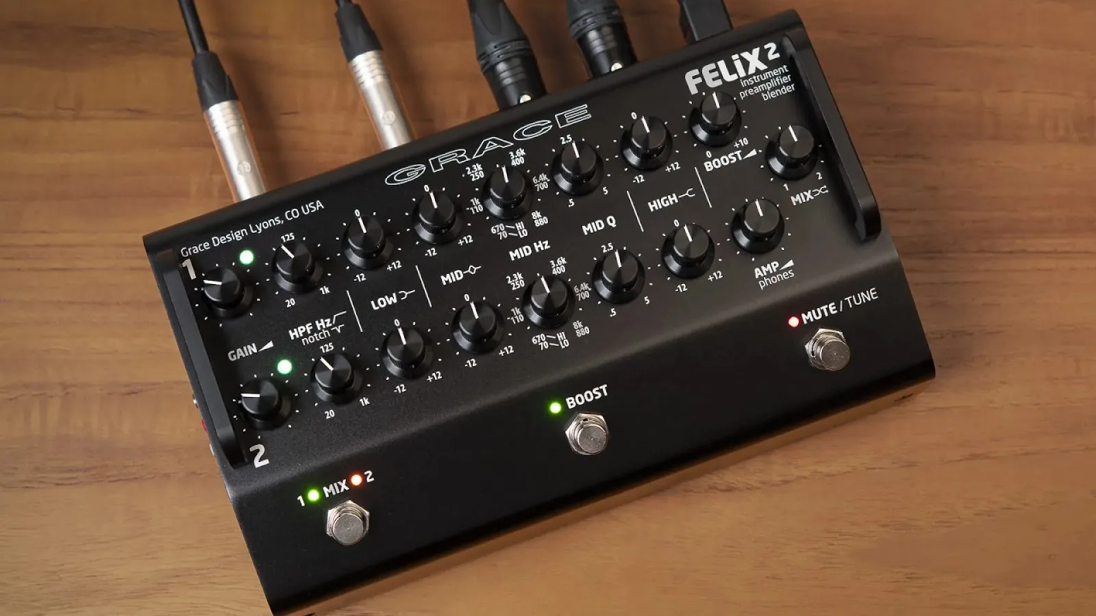 Top view of a black Grace Design FELiX 2 instrument preamplifier blender pedal connected to audio cables.
